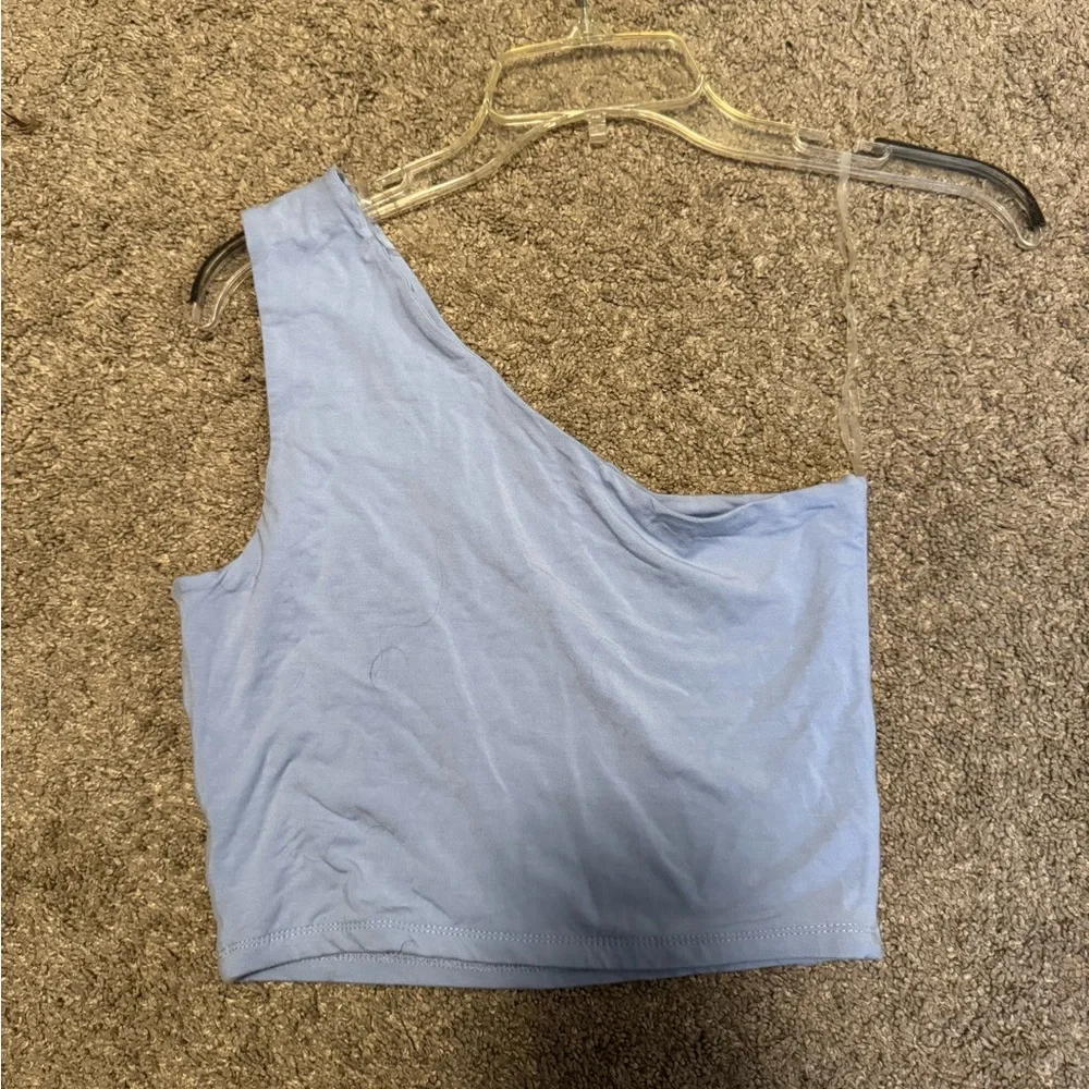light blue top with cut out on chest. size medium. lightly worn. one shoulder. - Picture 2 of 2